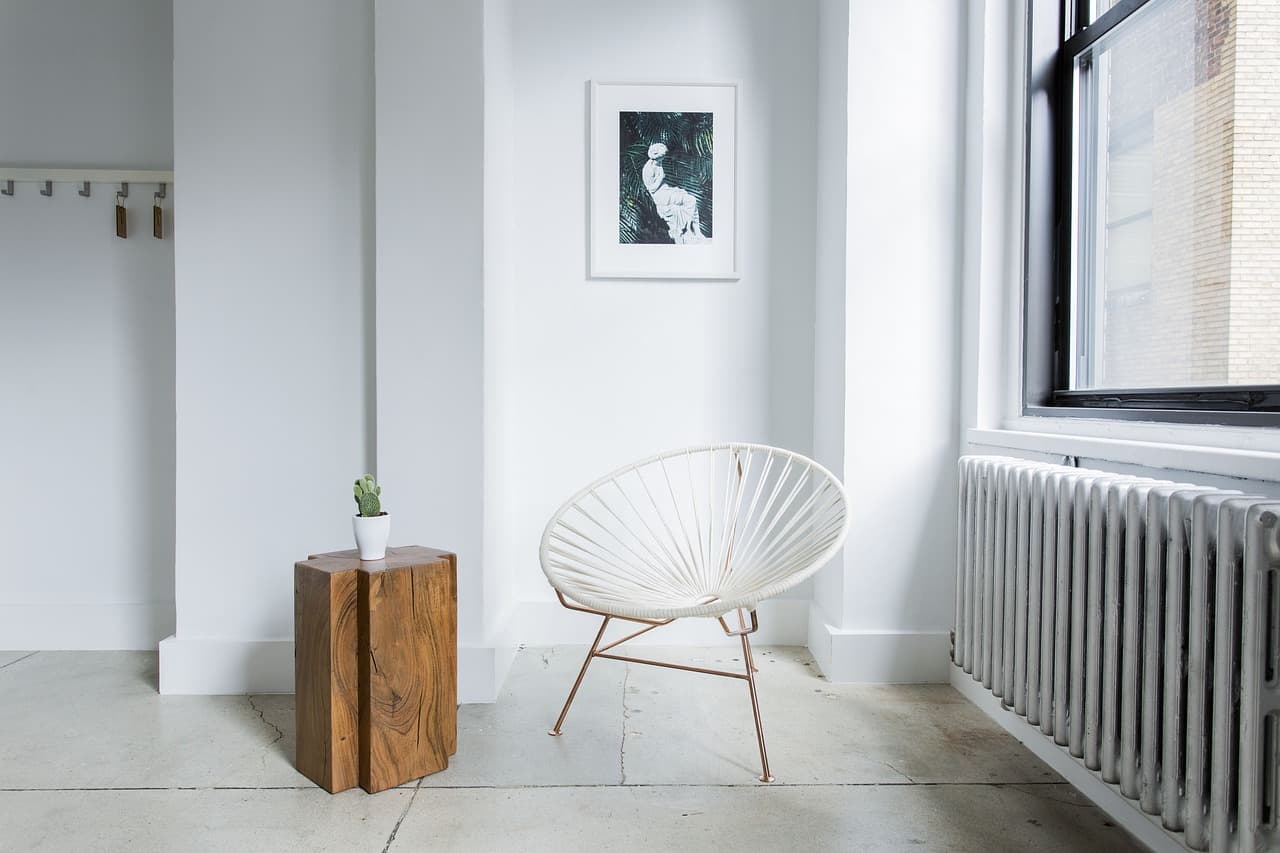 Bright living room with a column radiator under the window